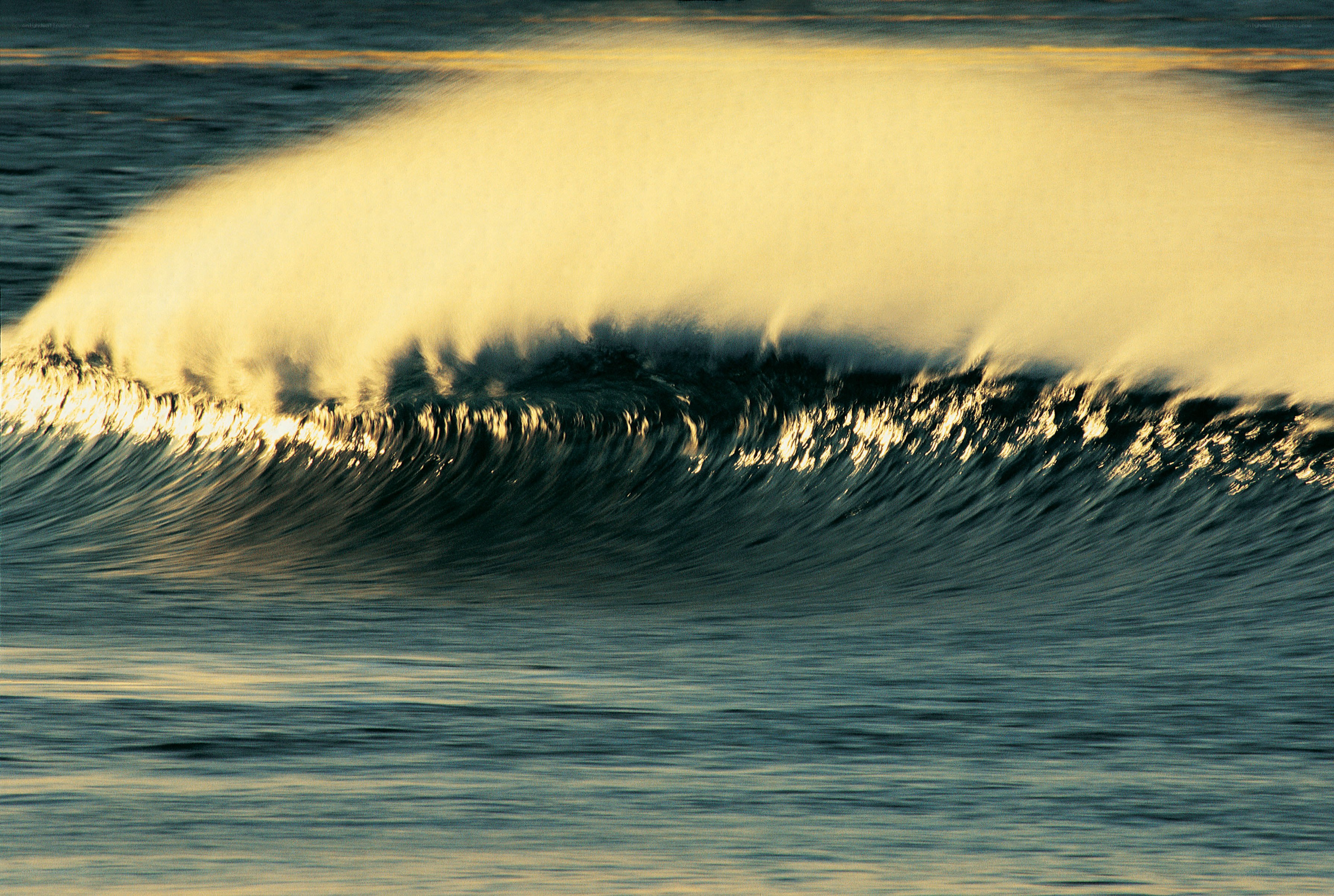 Wave crashing at sunset