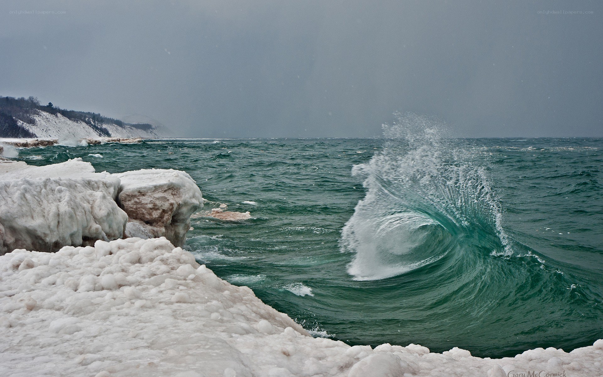 Wave crashing on icy shore