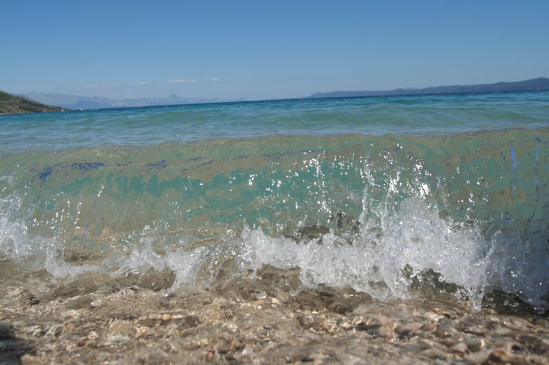 Wave crashing on pebbled shore