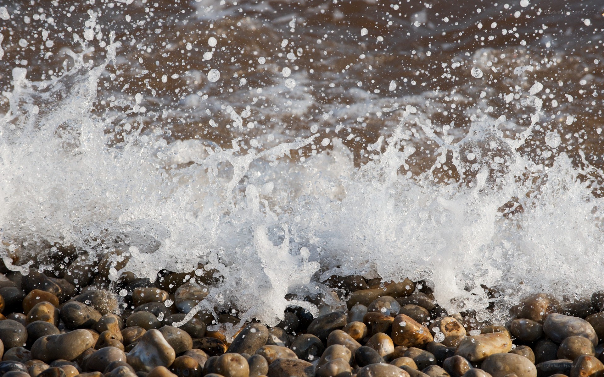 Wave crashing on pebbles