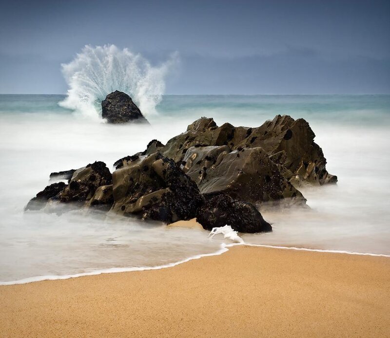 Wave crashing on rocks at beach