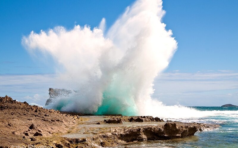 Wave crashing on rocky shore