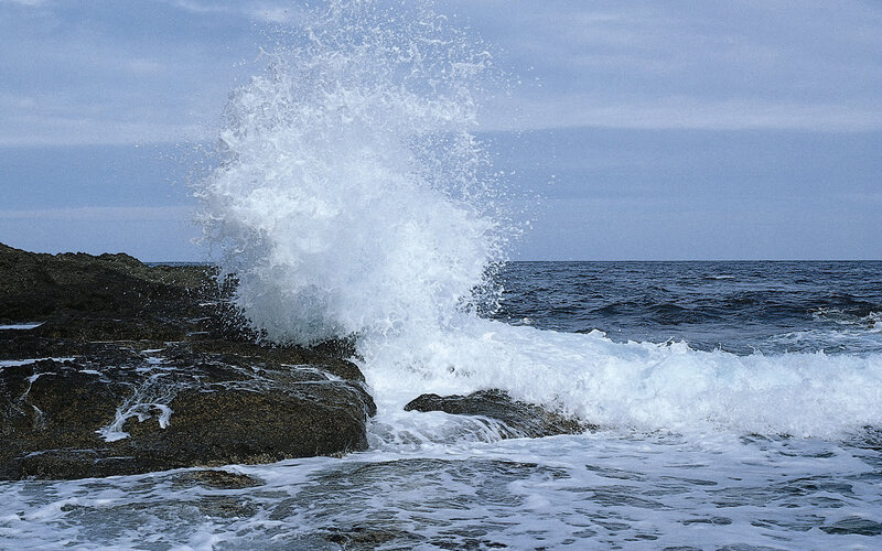 Wave crashing on rocky shore