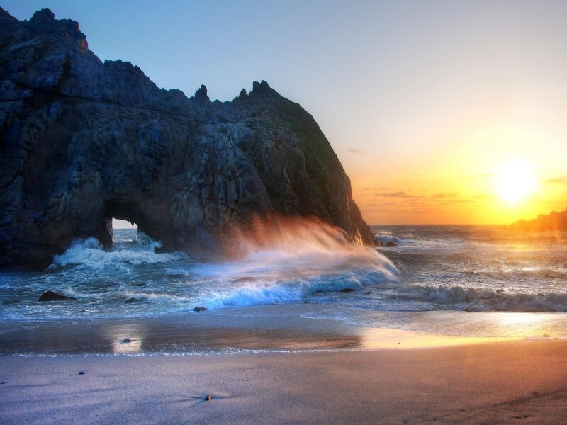 Wave Crashing Through Rock Arch — Blue