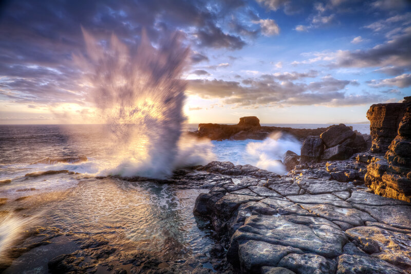 Wave Crashing Through Rock