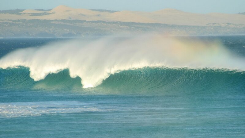 Wave crashing with rainbow