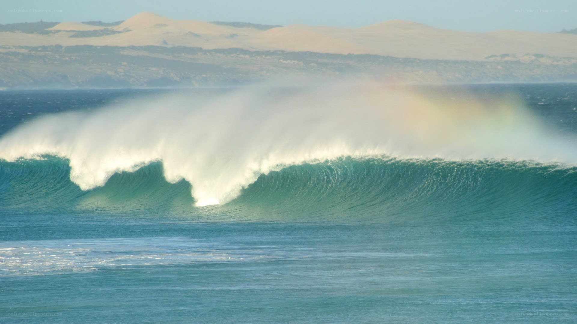 Wave crashing with rainbow