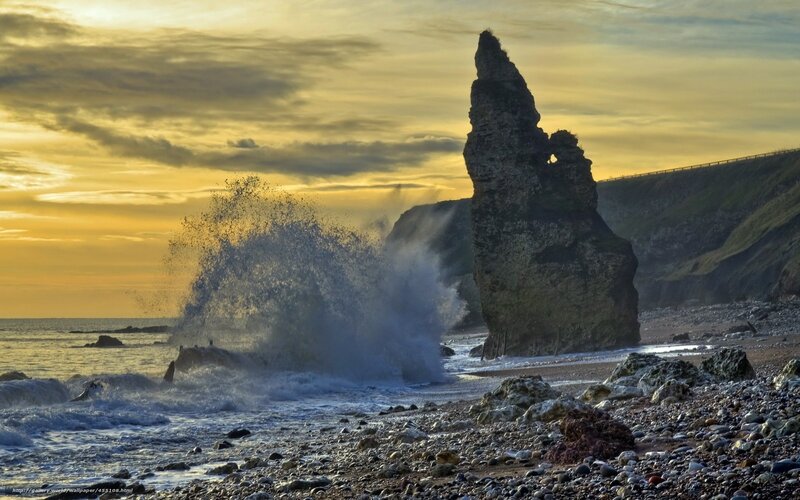 Waves crash against sea stack