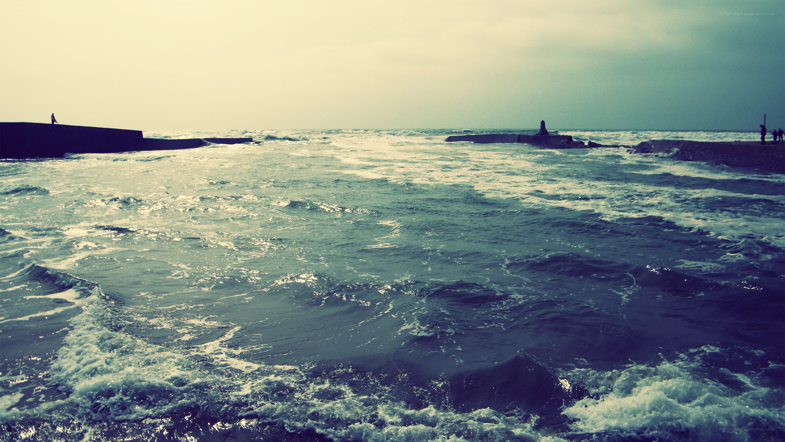 Waves crashing at a breakwater