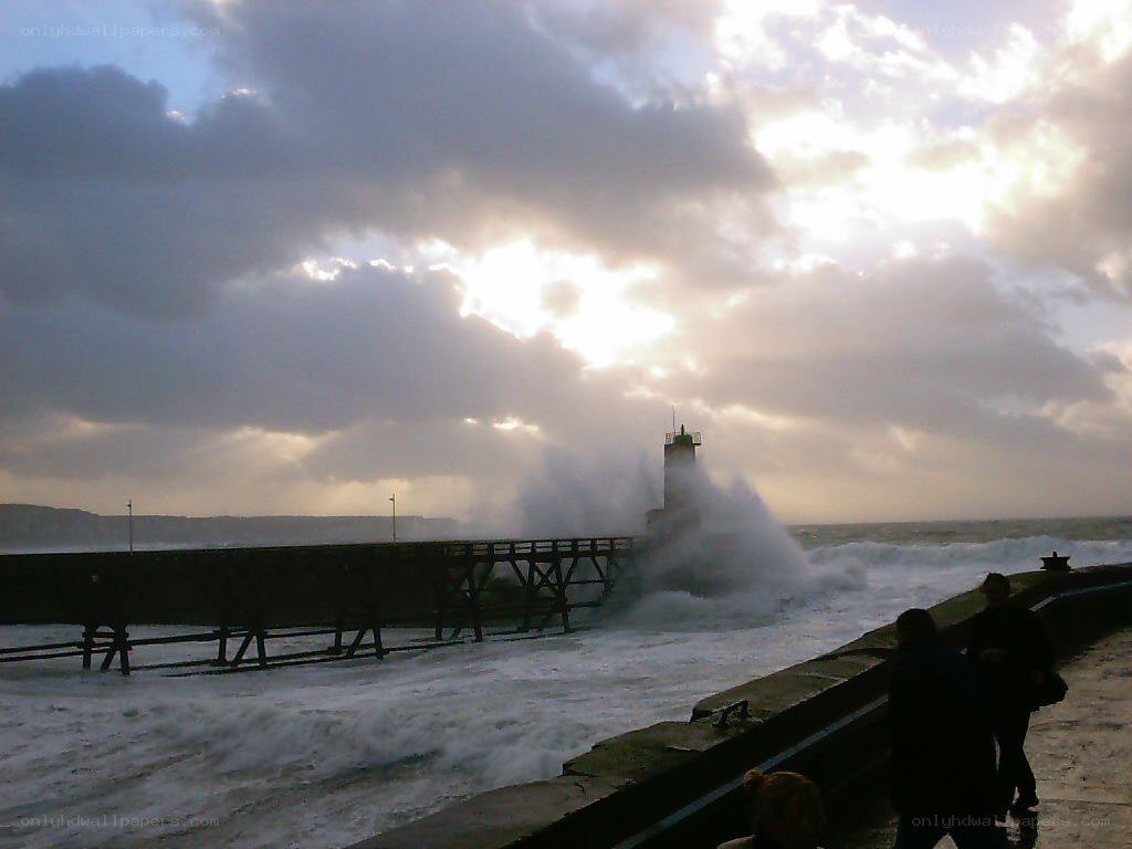 Waves crashing at a harbor