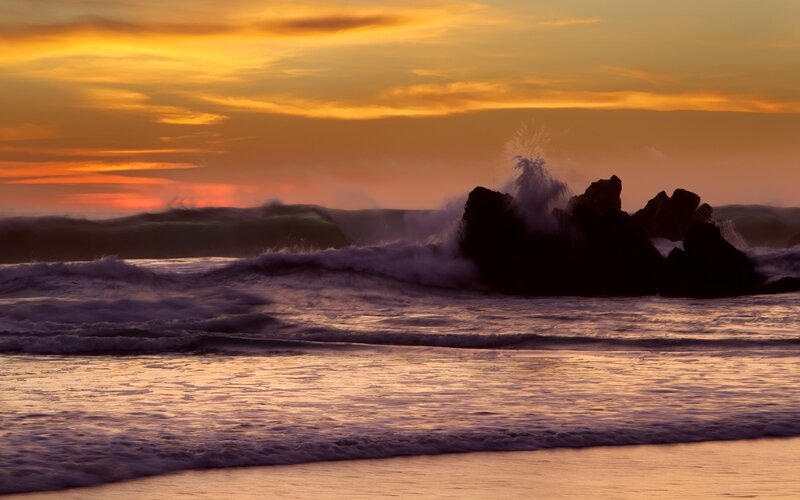 Waves crashing at sunset