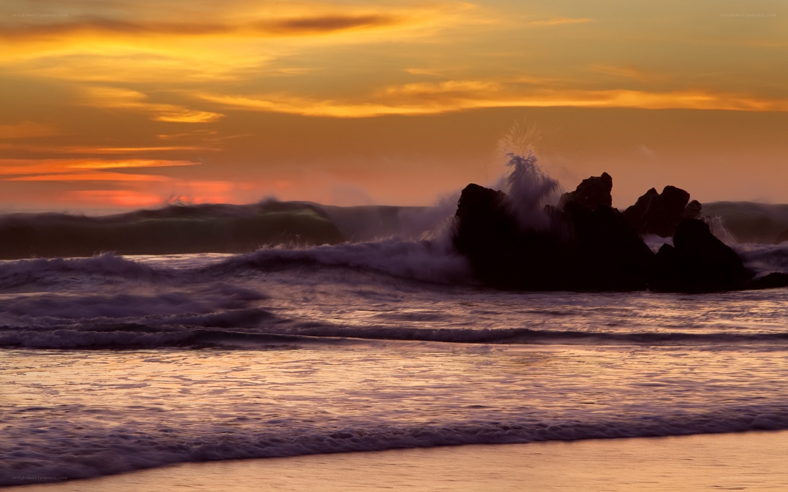 Waves crashing at sunset