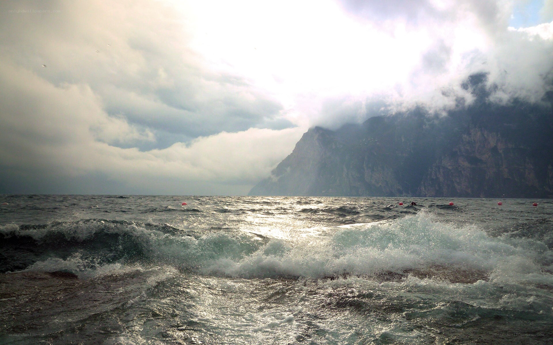Waves crashing near a mountain