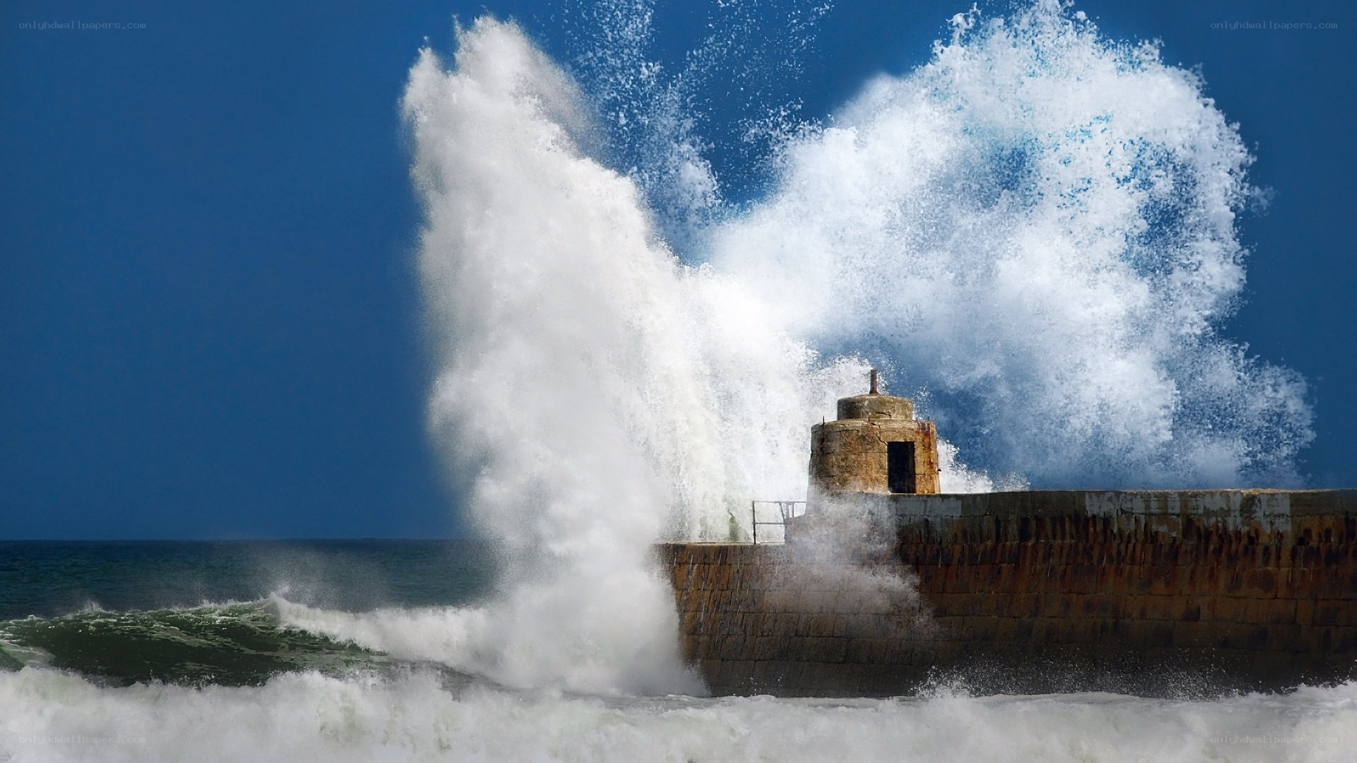 Waves crashing on a harbor wall