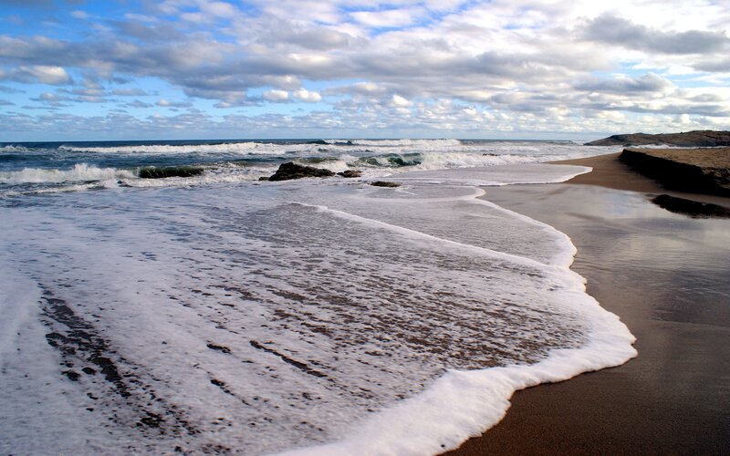 Waves crashing on a sandy beach