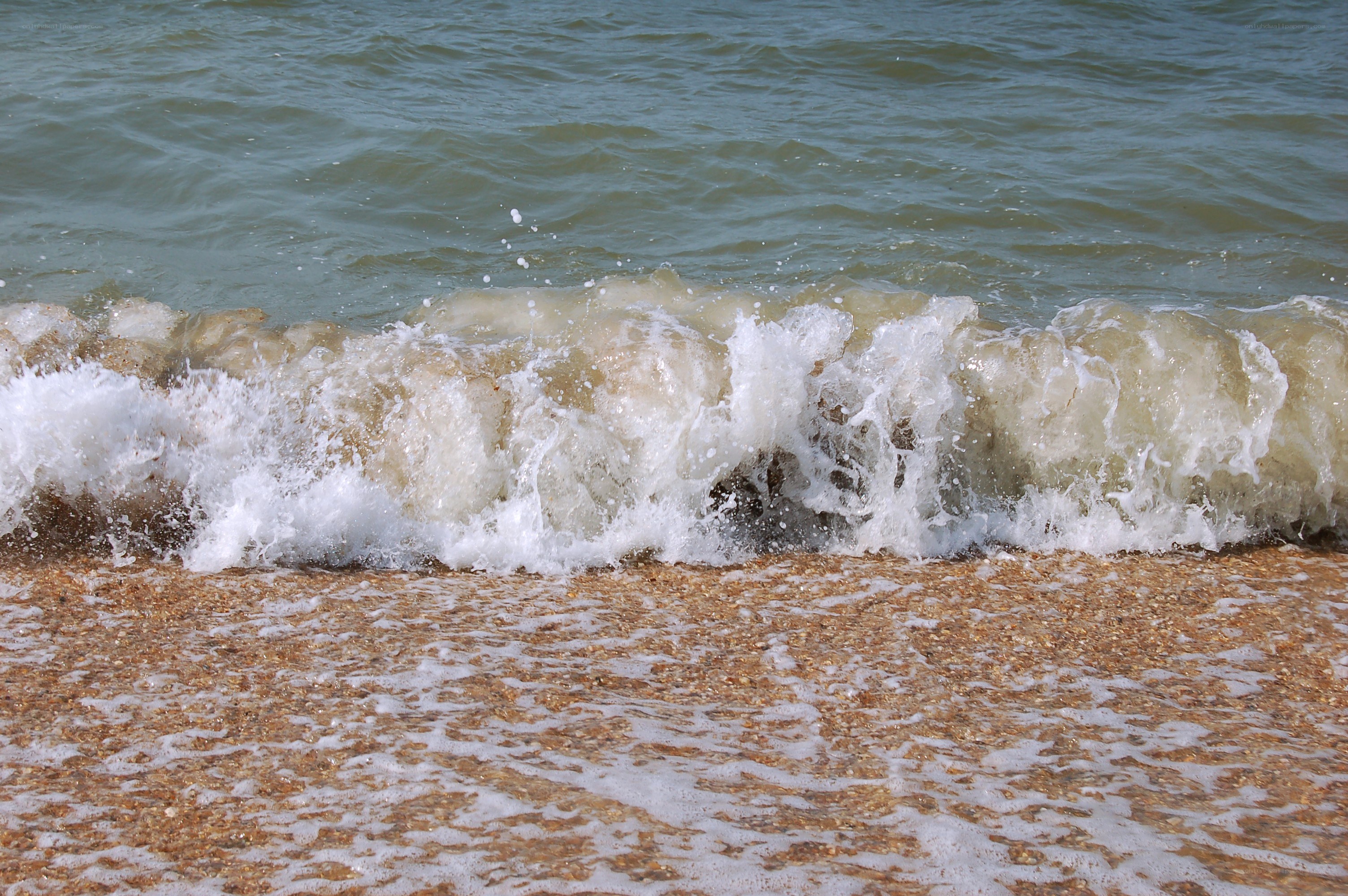 Waves crashing on a sandy beach