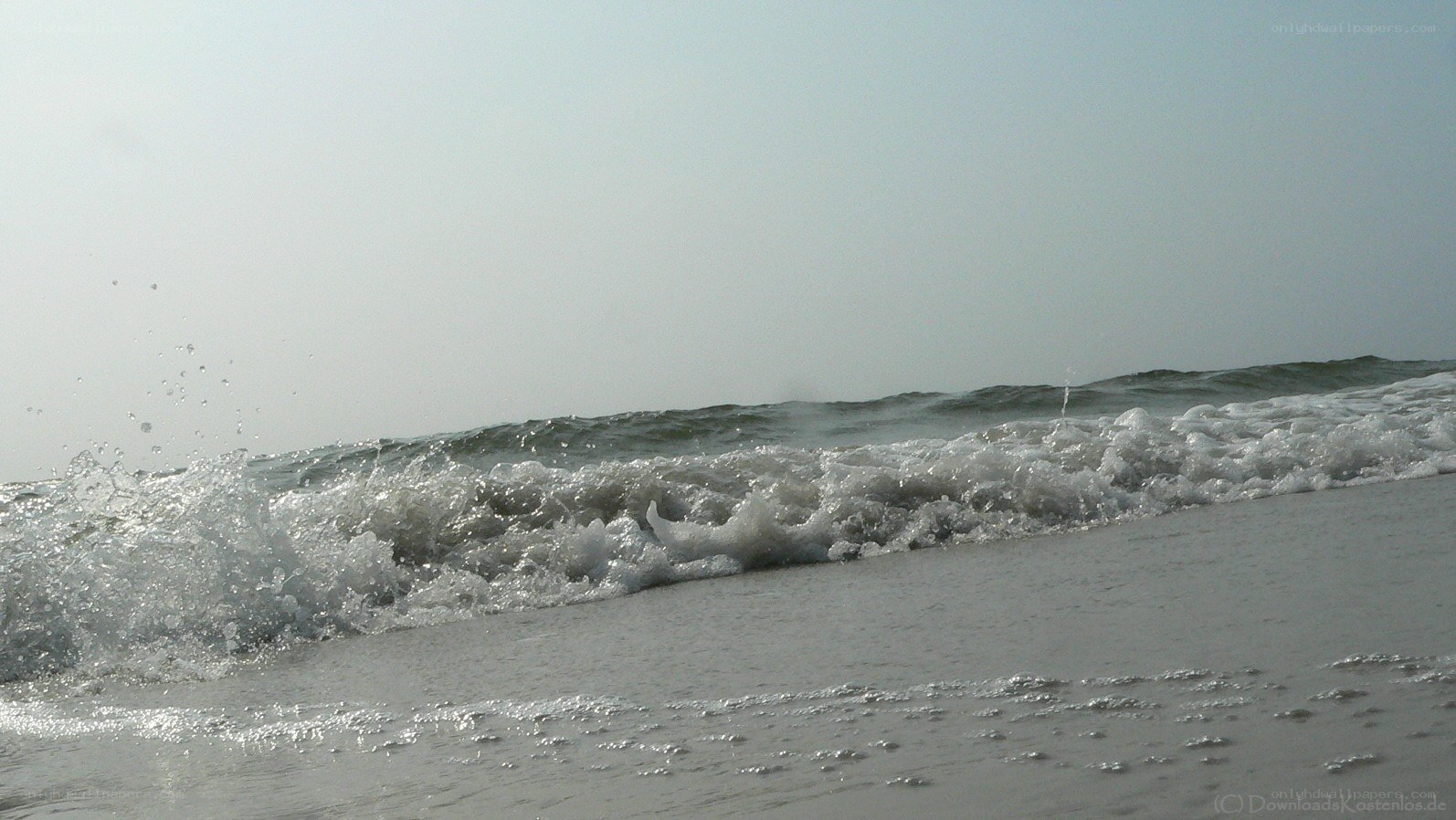 Waves crashing on a sandy beach