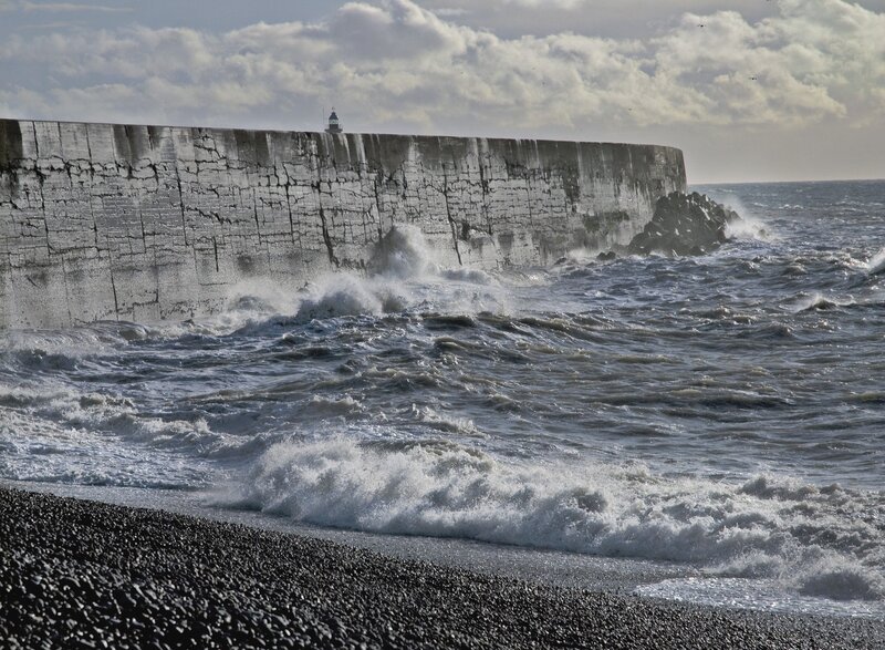 Waves crashing on a stone pier