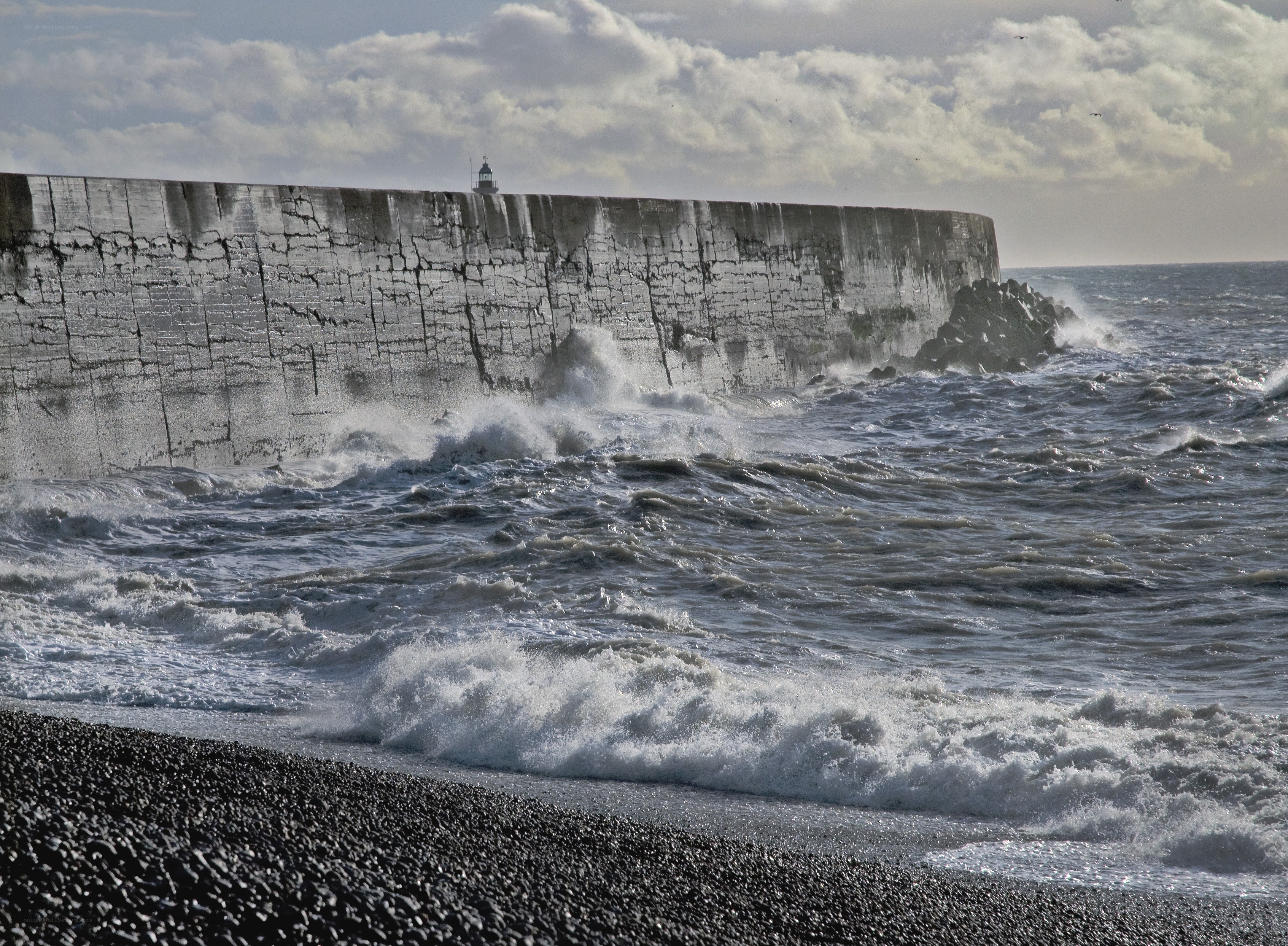 Waves crashing on a stone pier