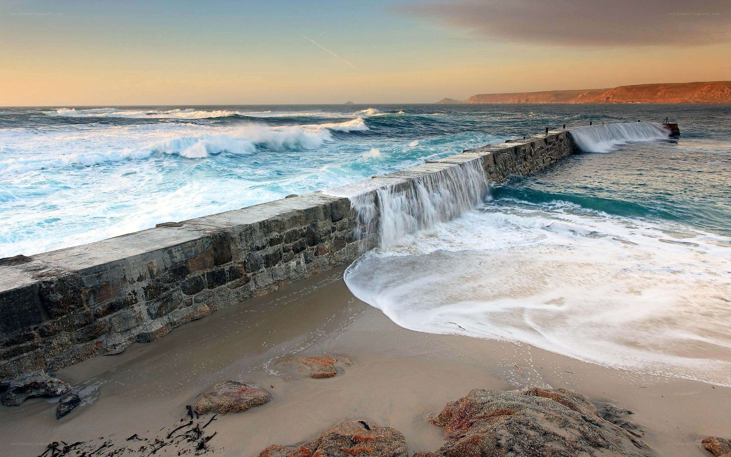 Waves crashing on a stone pier