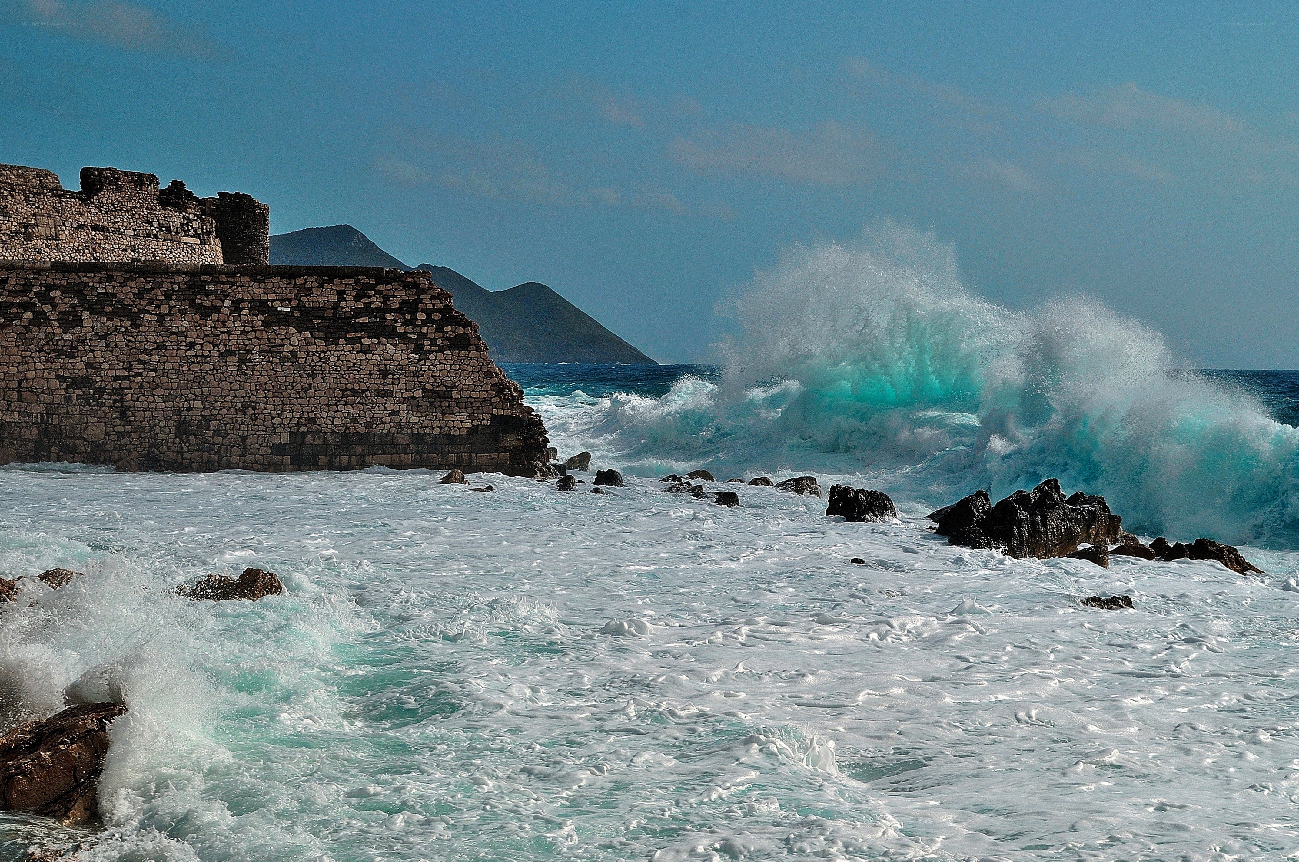 Waves crashing on ancient ruins