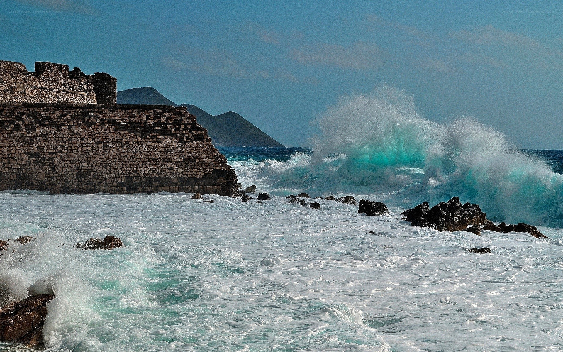 Waves crashing on ancient ruins