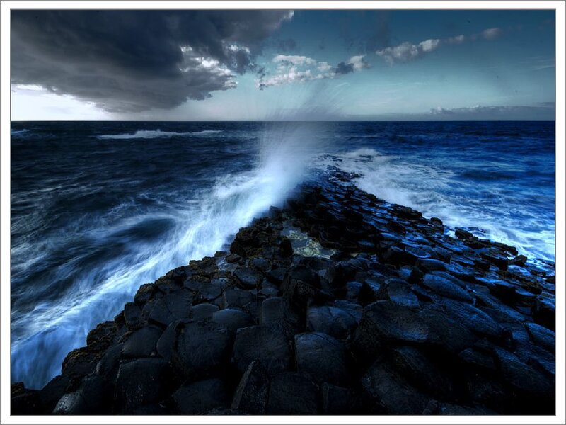 Waves crashing on basalt rocks