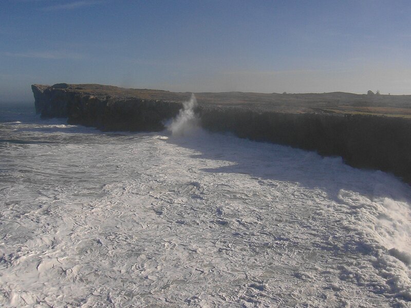 Waves crashing on cliffs