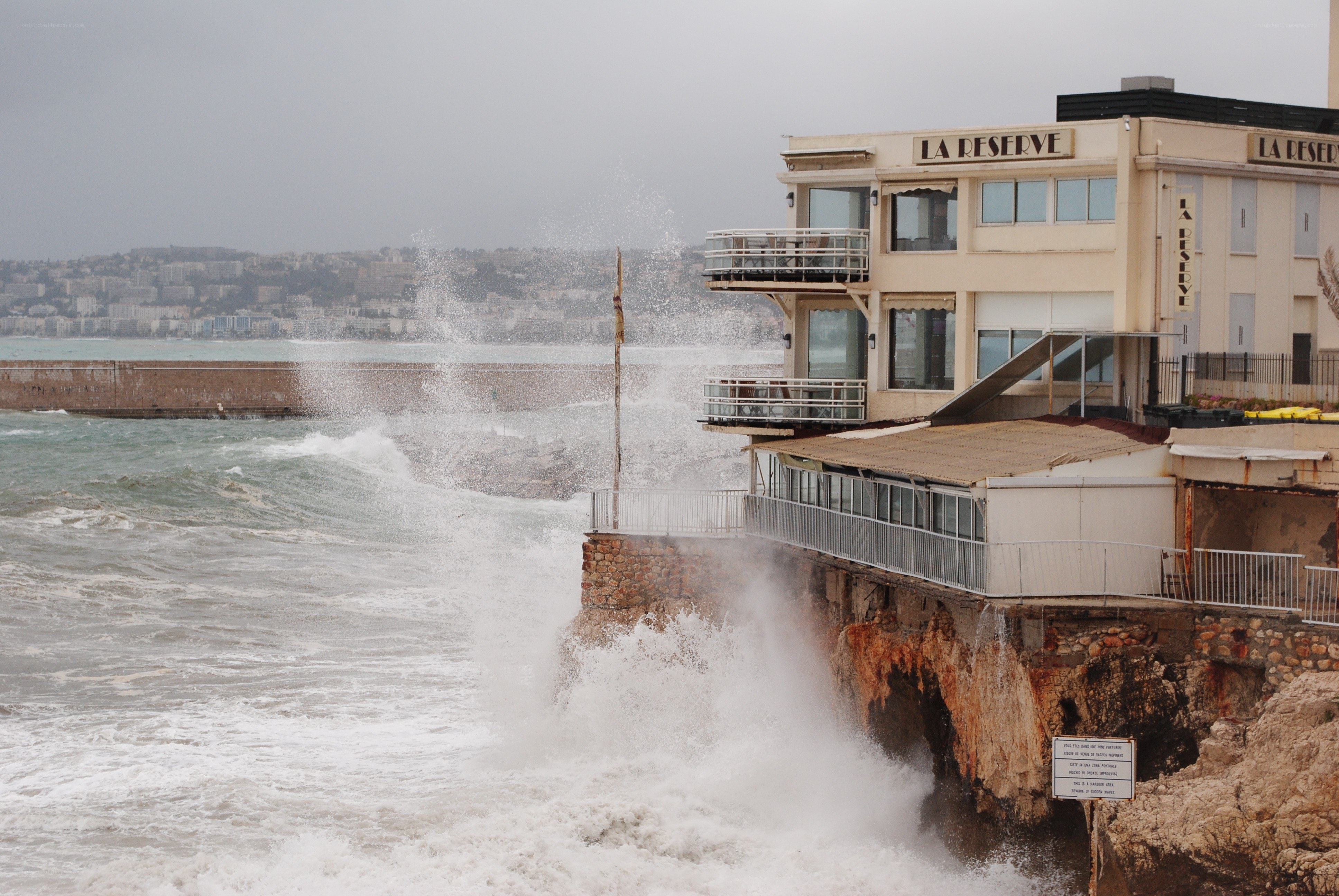 Waves crashing on coastal building