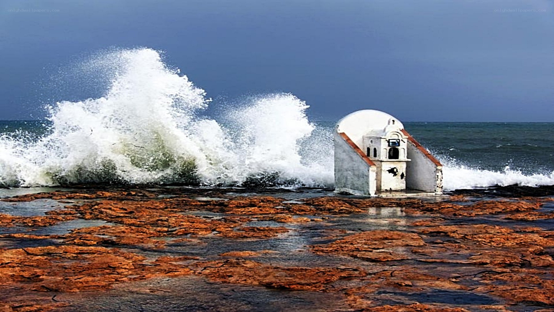 Waves crashing on coastal chapel