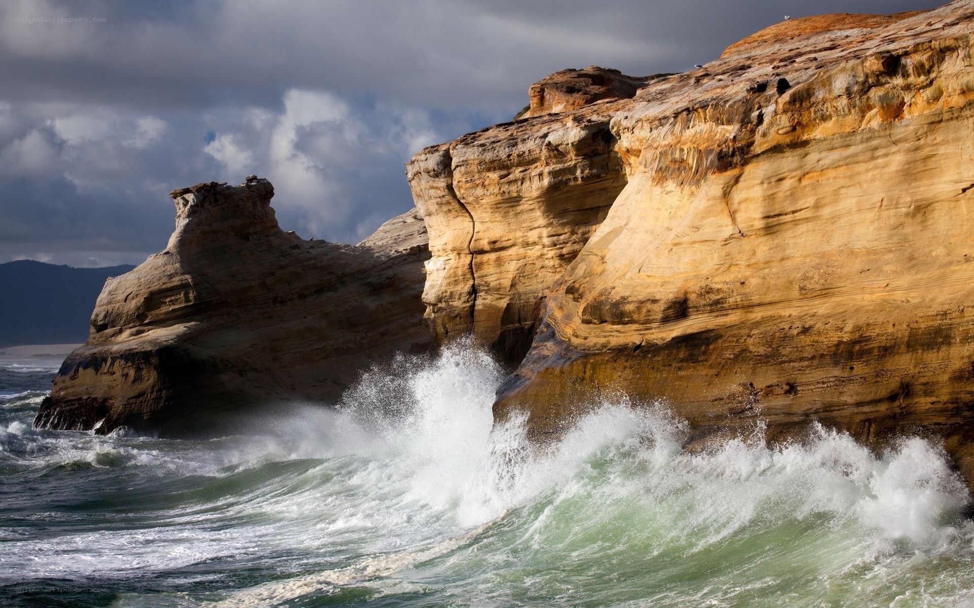 Waves crashing on coastal cliffs