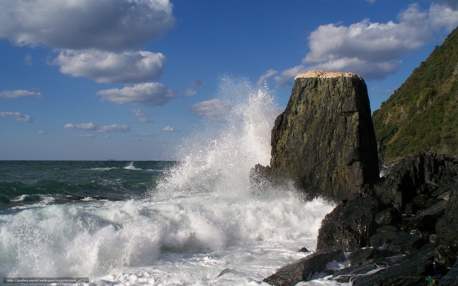 Waves crashing on coastal rock