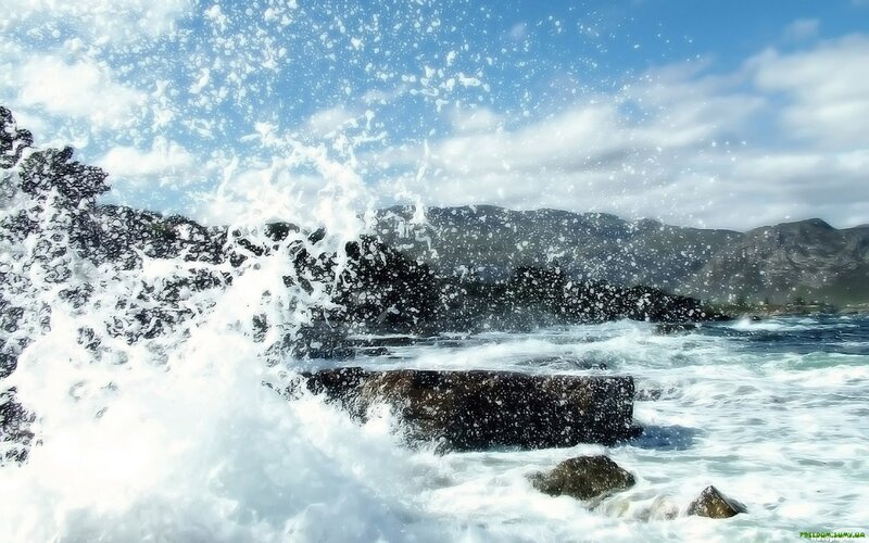 Waves crashing on coastal rocks