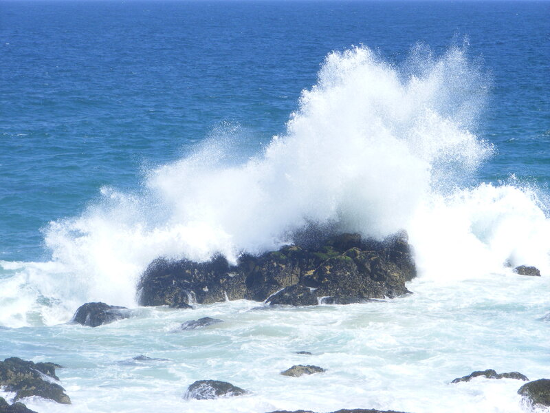Waves crashing on coastal rocks