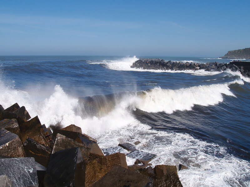 Waves crashing on coastal rocks