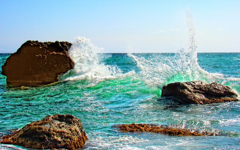 Waves crashing on coastal rocks