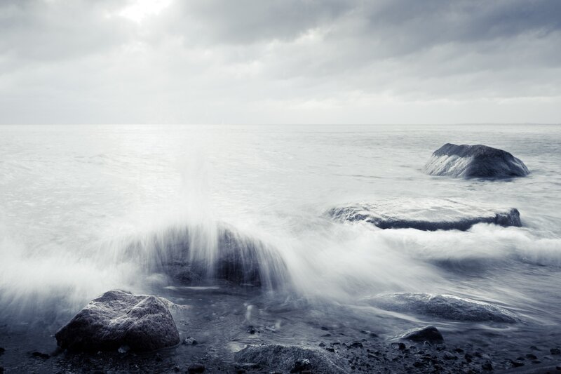 Waves crashing on coastal rocks