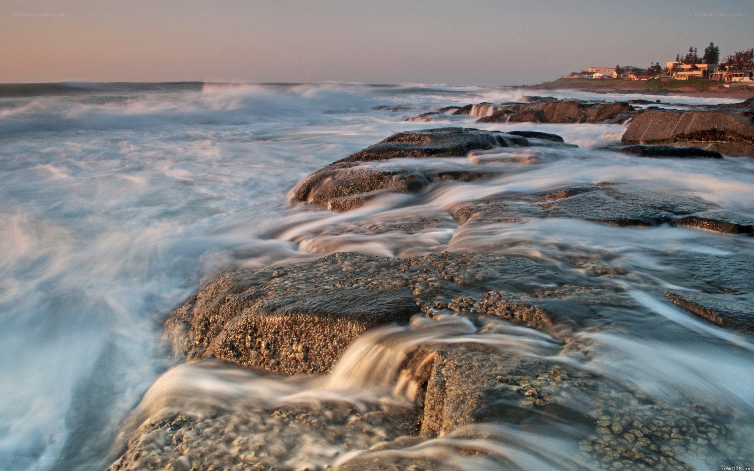 Waves crashing on coastal rocks