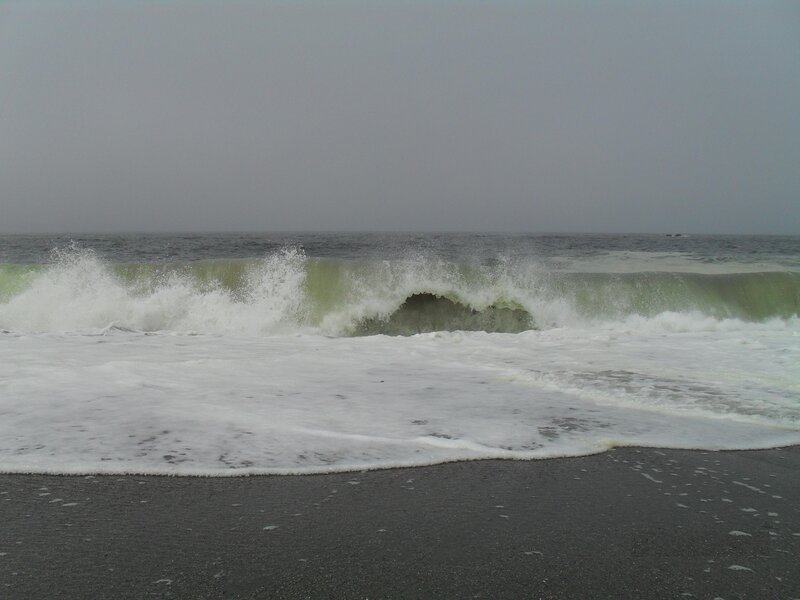 Waves crashing on dark beach