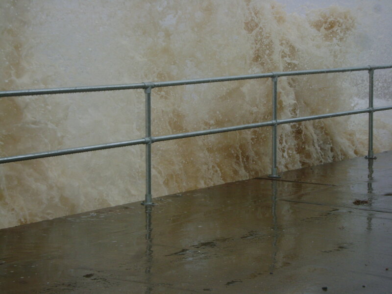 Waves Crashing on Pier — Brown