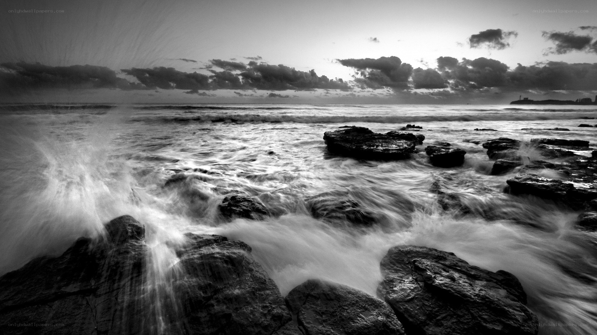Waves crashing on rocks at dusk
