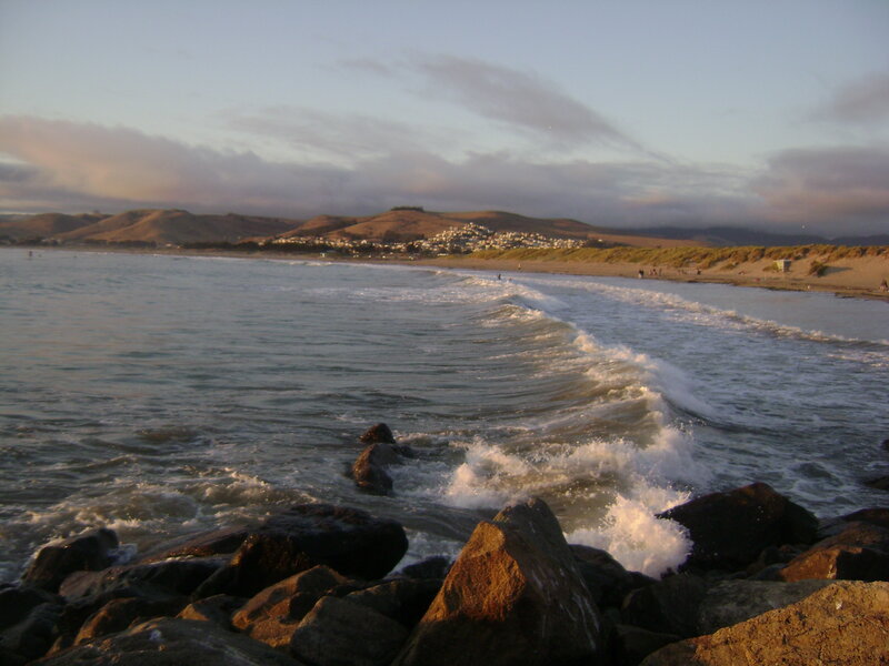 Waves crashing on rocks at sunset