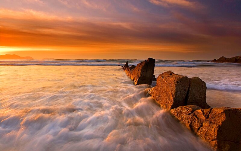 Waves Crashing on Rocks — Orange, Dramatic, Sunrise