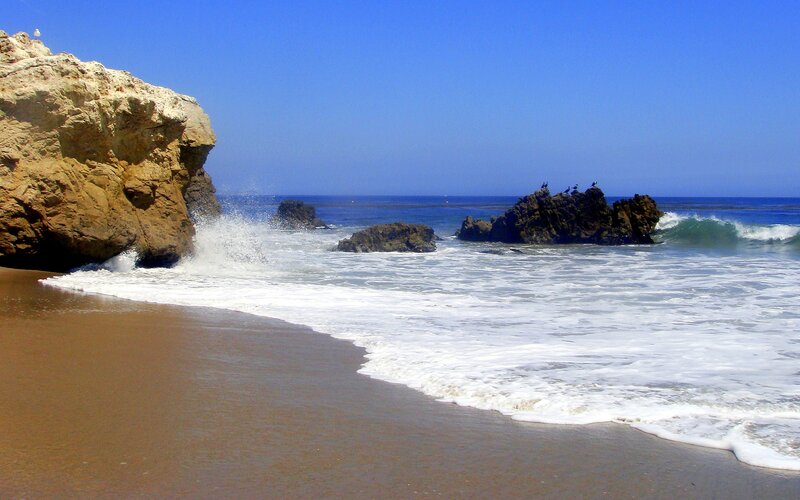 Waves Crashing on Rocky Beach — Blue