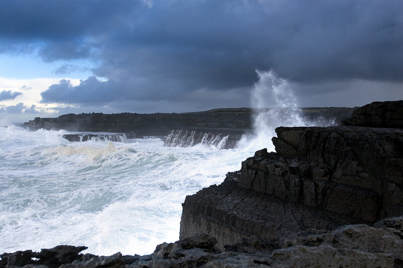Waves crashing on rocky cliffs