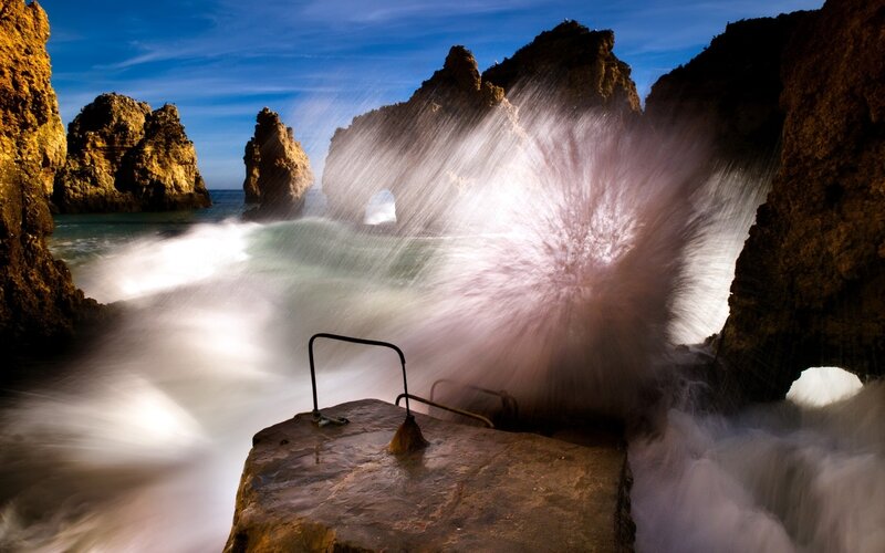 Waves crashing on rocky cliffs