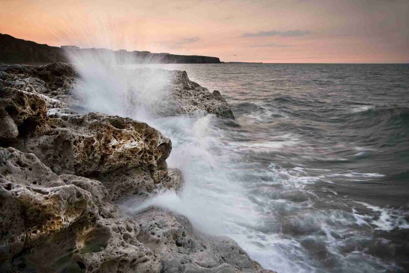 Waves crashing on rocky shore