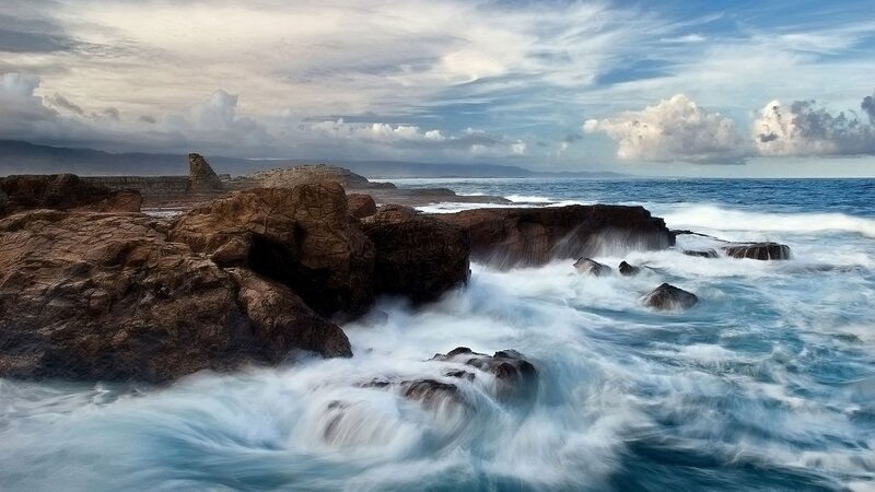 Waves crashing on rocky shore