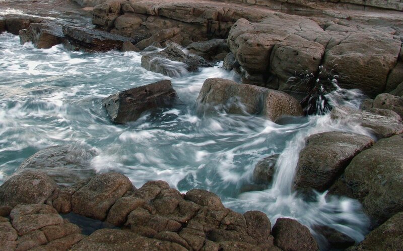 Waves crashing on rocky shore