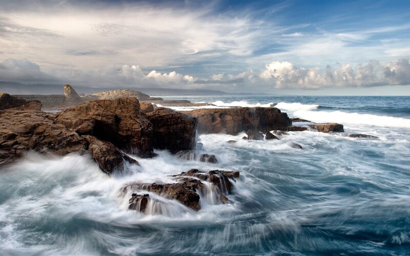 Waves crashing on rocky shore